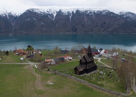 Den lille bygda Ornes med Urnes stavkirke ved Lustrafjorden.